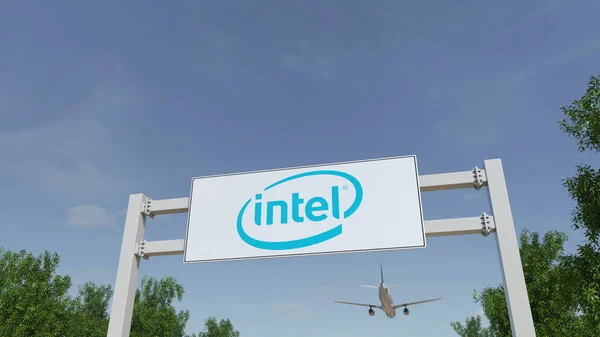 Airplane flying over advertising billboard with Intel Corporation logo. Editorial 3D rendering — Stock Photo, Image