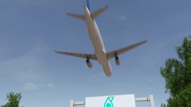 Flugzeug fliegt über Werbetafel mit Petroliam nasional berhad petronas Logo. Editorial 3D Rendering 4k Clip — Stockvideo