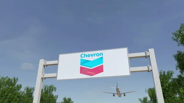 A repülőgép repül át reklám billboard Chevron Corporation logóval. Szerkesztői 3d-leképezés — Stock Fotó
