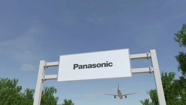 Flugzeug fliegt über eine Werbetafel mit dem Firmenlogo von Panasonic. redaktionelles 3D-Rendering — Stockfoto