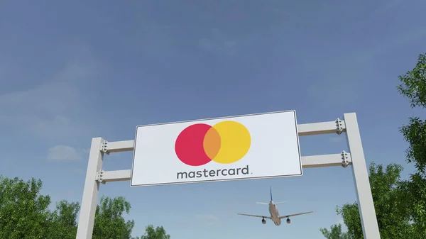 Flygplan som flyger över reklam skylt med Mastercard logo. Redaktionella 3d-rendering — Stockfoto