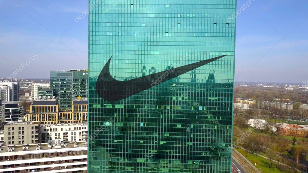 Aerial shot of office skyscraper with Nike inscription and logo. Editorial 3D
