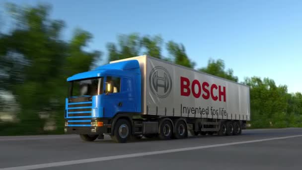 Semi-camion de fret avec logo Robert Bosch GmbH conduisant le long de la route forestière, boucle transparente. Clip éditorial 4K — Video