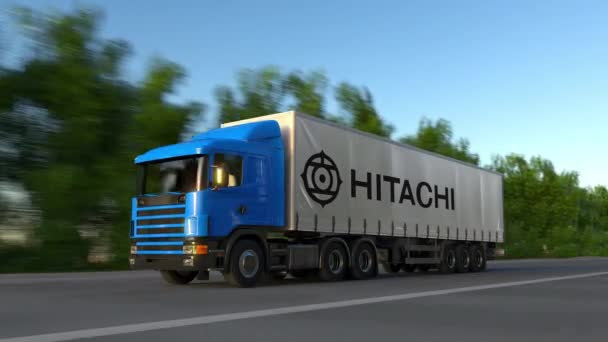 Frete semi-caminhão com logotipo Hitachi dirigindo ao longo da estrada da floresta, loop sem costura. Editorial 4K clip — Vídeo de Stock