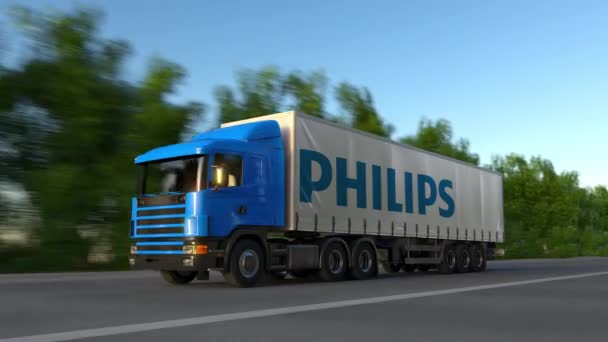 Frete semi-caminhão com logotipo Philips dirigindo ao longo da estrada da floresta, loop sem costura. Editorial 4K clip — Vídeo de Stock