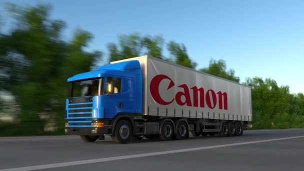 Camión semi de carga con el logotipo de Canon Inc. conduciendo a lo largo de la carretera forestal, bucle sin fisuras. Clip editorial 4K — Vídeos de Stock