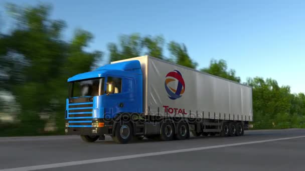 Ciężarówki naczepy towarowe z logo Total S.A. jazdy wzdłuż dróg leśnych, Płynna pętla. Klip redakcji 4k — Wideo stockowe