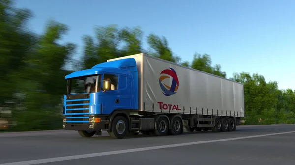 Ciężarówki naczepy towarowe z logo Total S.A. jazdy wzdłuż dróg leśnych. Redakcji renderowania 3d — Zdjęcie stockowe