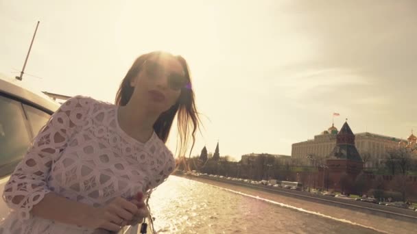 Mujer morena en gafas de sol mira al Kremlin de Moscú. Viajar a Rusia concepto. Vídeo en cámara lenta — Vídeos de Stock