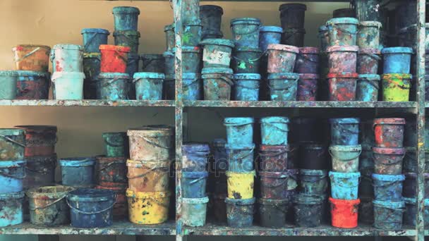 Industrial paint warehouse. Colorful stained buckets on the shelves. 4K dolly shot — Stock Video