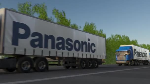 Freight semi trucks with Panasonic Corporation logo driving along forest road, seamless loop. Editorial 4K clip — Stock Video