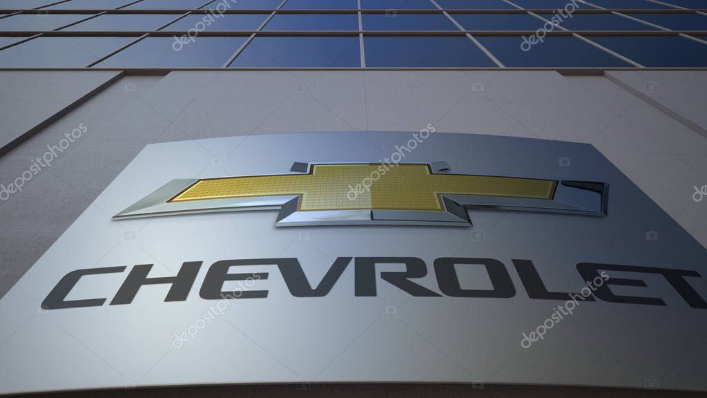Outdoor signage board with Chevrolet logo. Modern office building. Editorial 3D