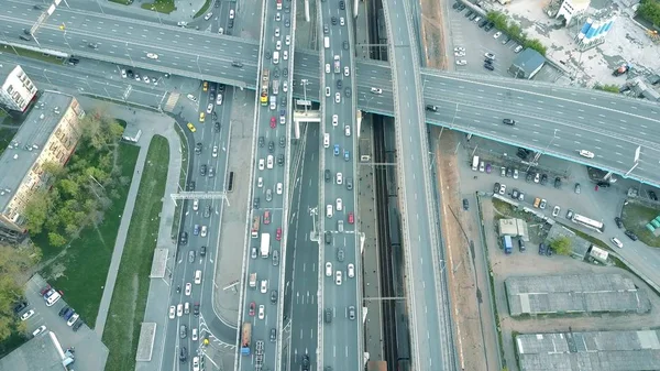 Aerial shot of traffic jam on a highway and moving train in the rush hour — Stock Photo, Image