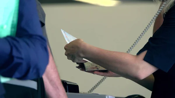 Checking passports and boarding cards at airport terminal