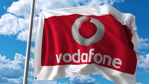 Macha flagą z Vodafone logo przeciwko poruszające się chmury. 4 k redakcji animacji — Wideo stockowe