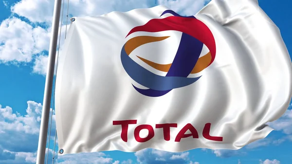 Waving flag with Total logo against sky and clouds. Editorial 3D rendering — Stock Photo, Image