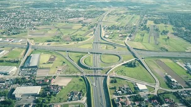 Scenic travelling aerial shot of big highway interchange in outskirts on a sunny summer day — Stock Video