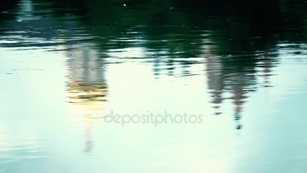 Slow motion shot of river ripple reflecting catholic orthodox cathedral in Moscow region, Russia — Stock Video