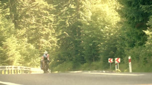 ザコパネ、ポーランド - 2017 年 6 月 24 日。2 つの陽気な大人男性自転車観光客が山のアスファルト道を登るします。夏の暑い日陽炎 — ストック動画