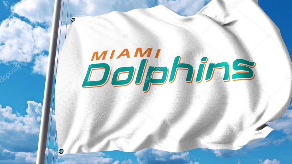 Waving flag with Miami Dolphins professional team logo. Editorial 3D