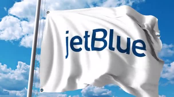 Acenando bandeira com logotipo JetBlue. Clipe editorial 4K — Vídeo de Stock