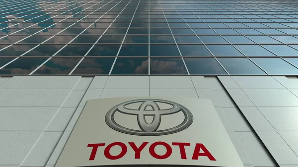 Tablero de señalización con logotipo de Toyota. Moderna fachada del edificio de oficinas. Representación Editorial 3D — Foto de Stock