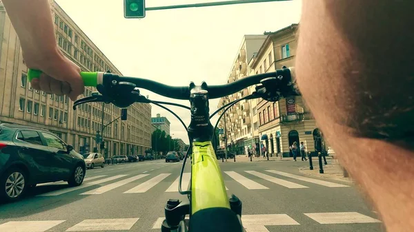 WARSAW, POLAND - JULY 18, 2017. POV shot of a man cycling along city center street — Stock Photo, Image