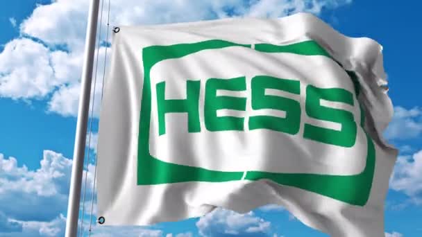 Mengayunkan bendera dengan logo Hess Corporation. Animasi editorial 4K — Stok Video