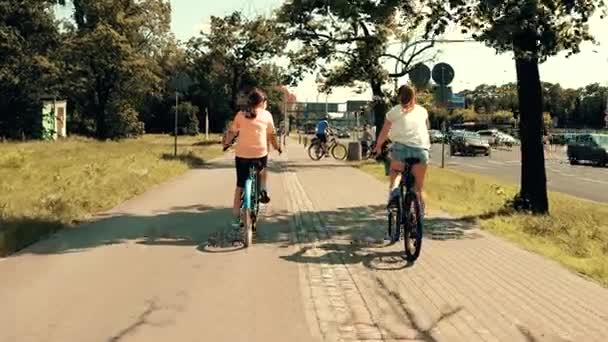 WARSAW, POLONIA - 11 de julio de 2017. Gente en bicicleta por la acera de la calle de la ciudad — Vídeo de stock