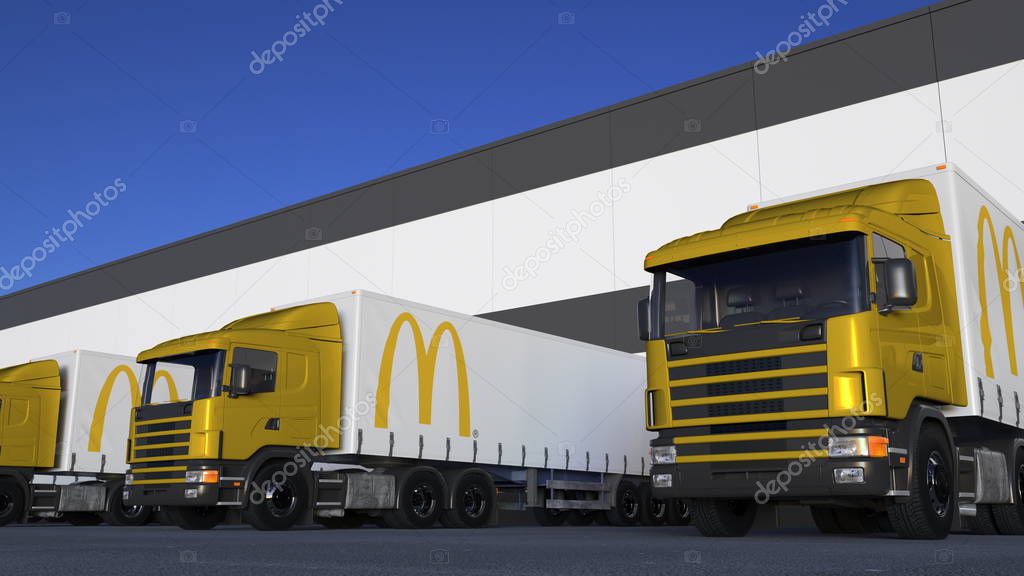 Freight semi trucks with McDonalds logo loading or unloading at warehouse dock. Editorial 3D