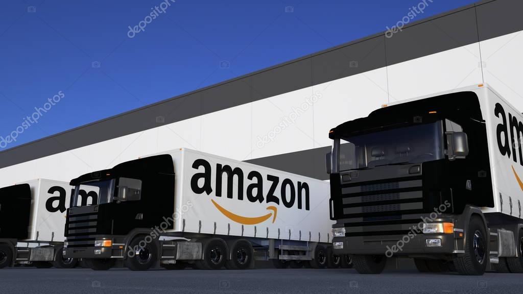 Freight semi trucks with Amazon.com logo loading or unloading at warehouse dock. Editorial 3D