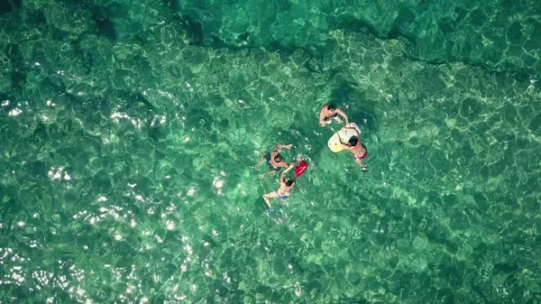 Aerial top down view of a adult couples bathing in the sea
