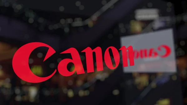 Logo de Canon Inc. en el vidrio contra el centro de negocios borroso. Representación Editorial 3D —  Fotos de Stock
