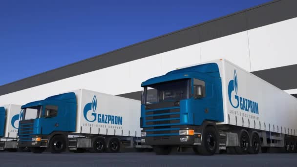 Freight semi trucks with Gazprom logo loading or unloading at warehouse dock, seamless loop. Editorial 4K animation — Stock Video