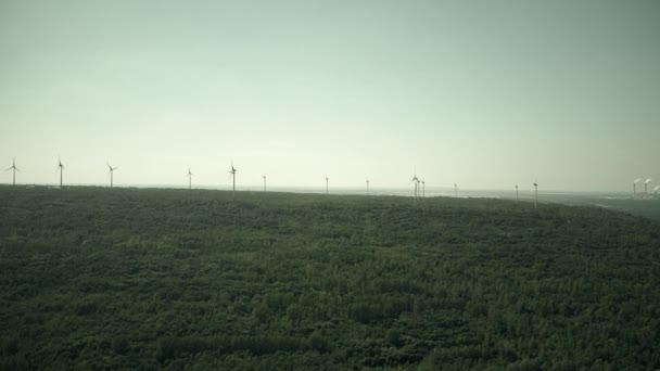 Windmills and distant smoking stacks of a traditional power plant — Stock Video