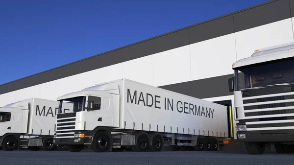 Frakt semi lastbilar med Made In Germany bildtext på släpet lastning eller lossning. Road cargo transport 3d-rendering — Stockfoto