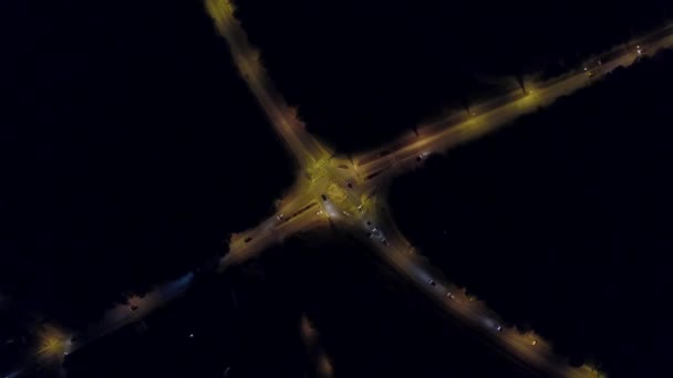 Aerial top down view time lapse of a rural European car road roundabout at night — Stock Video