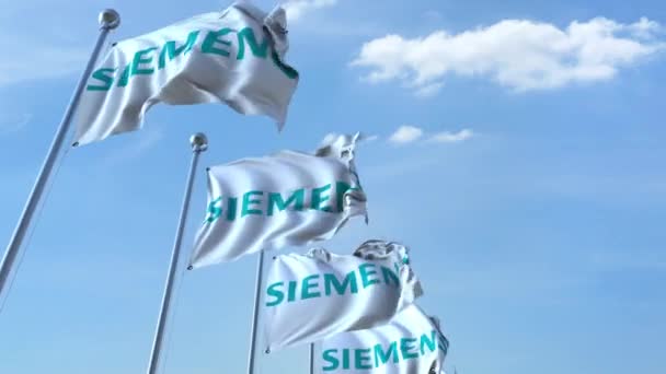 Ondeando banderas con el logotipo de Siemens contra el cielo, lazo sin costuras. Animación editorial 4K — Vídeo de stock