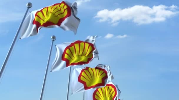 Ondeando banderas con el logotipo de Shell contra el cielo, lazo sin costuras. Animación editorial 4K — Vídeo de stock