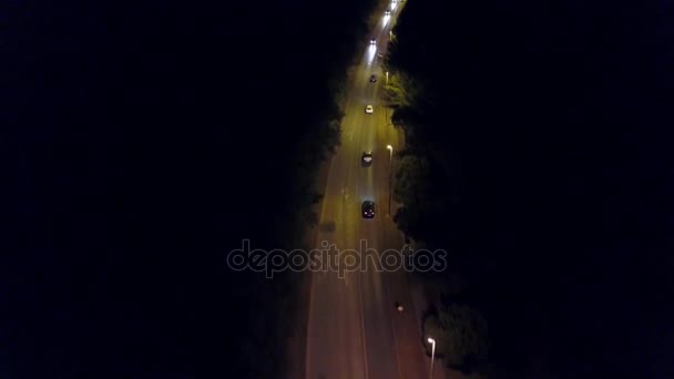 Aerial down view shot of a rural European car road at night — Stock Video