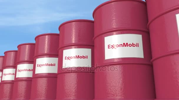 Row of metal barrels ExxonMobil Corporation logo against sky, seamless loop. 4K editorial animation — Stock Video