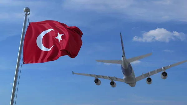 Commercial airplane landing behind waving Turkish flag. Travel to Turkey conceptual 3D rendering — Stock Photo, Image