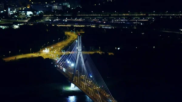 Aerial night shot of the modern guyed bridge over the Vistula river in Warsaw, Poland — Stock Photo, Image