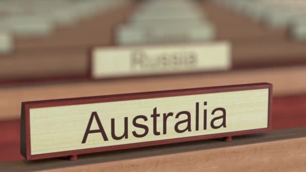 Austrália sinal de nome entre diferentes placas de países na organização internacional. Renderização 3D — Vídeo de Stock