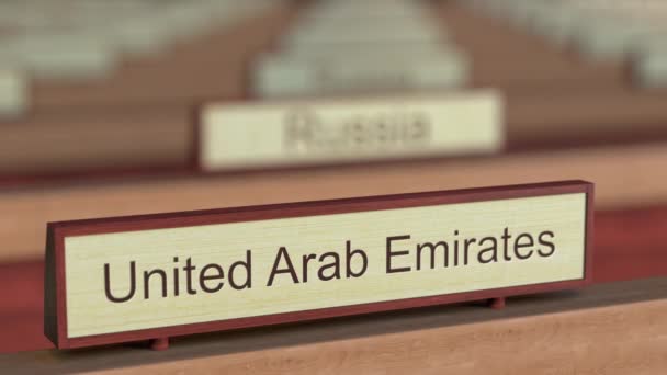 United Arab Emirates name sign among different countries plaques at international organization — Stock Video