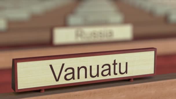 Vanuatu name sign among different countries plaques at international organization — Stock Video