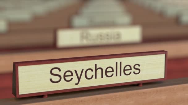Seychelles name sign among different countries plaques at international organization — Stock Video