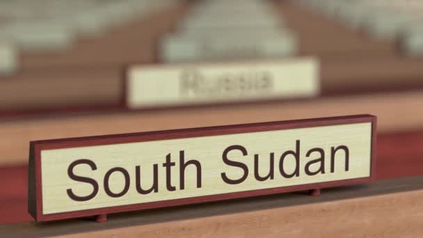 South Sudan name sign among different countries plaques at international organization — Stock Video