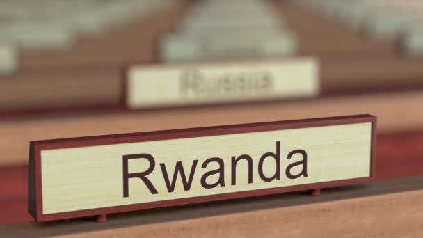 Rwanda name sign among different countries plaques at international organization — Stock Video