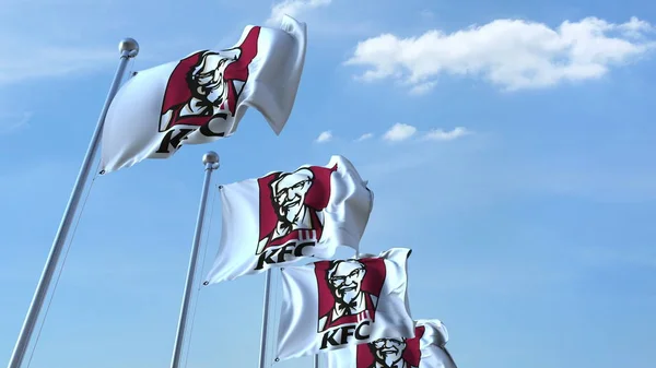 Ondeando banderas con el logotipo de KFC contra el cielo, representación editorial 3D —  Fotos de Stock
